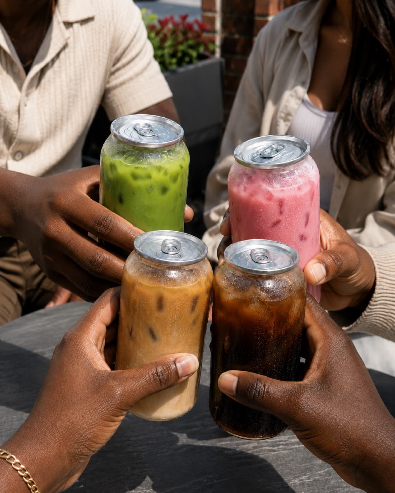 Friends toasting with clear canned drinks